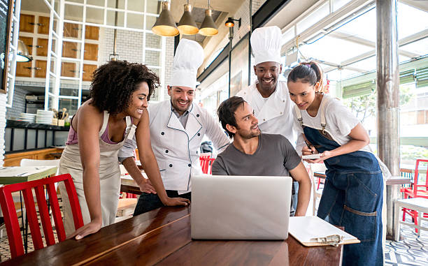 Group of people working at a restaurant and talking in a business meeting
